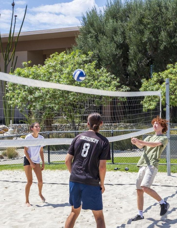 Students play 排球 outside McConnell Center